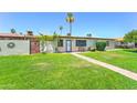 Lush front yard featuring a brick path and views of mature trees at 6721 E Mcdowell Rd # B309, Scottsdale, AZ 85257