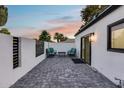 Cozy outdoor patio with modern chairs, privacy walls, and views of palm trees at sunset at 8618 E Via De Encanto --, Scottsdale, AZ 85258