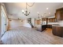 Spacious living room features tile floors, recessed lighting, and leads to the kitchen, dining area, and staircase at 10036 E Naranja Ave, Mesa, AZ 85209
