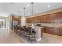 Beautiful kitchen featuring a center island with bar stool seating, granite counters, and stainless steel appliances at 10650 E Palladium Dr, Mesa, AZ 85212