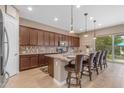 Beautiful kitchen featuring a center island with bar stool seating, granite counters, and stainless steel appliances at 10650 E Palladium Dr, Mesa, AZ 85212