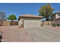Two-car garage with large driveway and desert landscaping at 12117 N 127Th Dr, El Mirage, AZ 85335