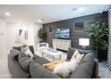 A contemporary living room featuring a gray sofa, stylish decor, and ample seating arrangement at 13244 N 146Th Ln, Surprise, AZ 85379