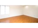 Empty bedroom with light wood floors and a large window at 16644 N 33Rd St # 101, Phoenix, AZ 85032