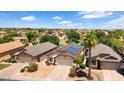 View of home featuring solar panels, landscaping, and access to the community lake at 17115 N Larkspur Ln, Surprise, AZ 85374