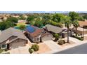 Aerial view of home showcasing solar panels and proximity to community lake at 17115 N Larkspur Ln, Surprise, AZ 85374
