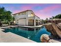 Beautiful backyard pool with rock features, perfect for relaxation and outdoor enjoyment at 1755 E Tonto Dr, Chandler, AZ 85249