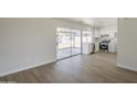 Open living area flowing into a modern kitchen, with backyard access through large sliding glass doors at 17848 N 34Th Ln, Phoenix, AZ 85053