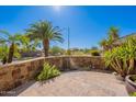 Charming front courtyard with brickwork, lush greenery, and desert landscaping at 20809 N 17Th St, Phoenix, AZ 85024
