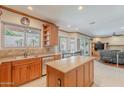 Open kitchen with island, stainless steel appliances, and views of the living and dining areas at 20809 N 17Th St, Phoenix, AZ 85024