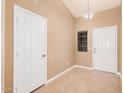 Bright foyer featuring neutral paint, tile floors, high ceilings, and a pendant light at 3343 W Lone Cacuts Dr, Phoenix, AZ 85027