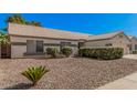 Inviting single-story home with desert landscaping, manicured bushes, and neutral exterior paint at 3343 W Lone Cacuts Dr, Phoenix, AZ 85027