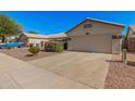 Single-story home featuring a spacious driveway, desert landscaping, and two-car garage at 3343 W Lone Cacuts Dr, Phoenix, AZ 85027