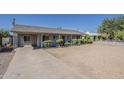 Single-story home with gravel front yard, covered walkway, and a concrete driveway at 3347 W Roma Ave, Phoenix, AZ 85017
