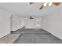 Spacious living room with neutral walls, plush carpeting, and stylish ceiling fans at 3514 W Helena Dr, Glendale, AZ 85308