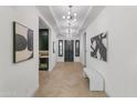 Elegant entryway featuring herringbone floors, designer lighting, and a beverage center for sophisticated living at 3890 E Andalusia Ave, Gilbert, AZ 85298