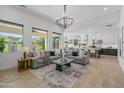 Bright, open-concept living room showcases large windows, modern furnishings, and seamless flow to the kitchen at 3890 E Andalusia Ave, Gilbert, AZ 85298