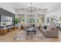 Stylish living room with large windows, comfortable seating, and a chic entertainment center for relaxation at 3890 E Andalusia Ave, Gilbert, AZ 85298