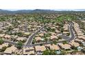 Expansive aerial view of a residential community nestled among lush golf courses and scenic mountain views at 4507 E Duane Ln, Cave Creek, AZ 85331