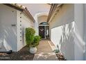 Inviting entrance pathway with decorative plants and stylish door with sidelight, offering a warm welcome at 4507 E Duane Ln, Cave Creek, AZ 85331