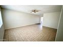 Spacious living room with tile flooring and a ceiling fan, creating a comfortable and inviting space at 4625 W Thomas Rd # 48, Phoenix, AZ 85031