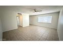 Inviting living area with tile flooring, ceiling fan, and a large window, offering a bright and airy atmosphere at 4625 W Thomas Rd # 48, Phoenix, AZ 85031
