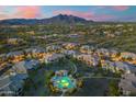 Scenic aerial view of the community pool and surrounding homes in the evening at 5100 E Rancho Paloma Dr # 1044, Cave Creek, AZ 85331