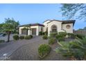 Attractive home with a well-kept lawn, desert landscaping and two-car garage at 5243 E Windstone Trl, Cave Creek, AZ 85331