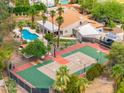 Expansive backyard with a tennis court, sparkling pool, and a covered patio perfect for entertaining at 5540 E Mercer Ln, Scottsdale, AZ 85254