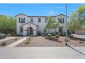 Inviting two-story home with desert landscaping, grey shutters, and a welcoming covered entrance at 5805 W Warner St, Phoenix, AZ 85043