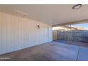 Attached carport featuring concrete floors, a door to the backyard, and ample parking space at 656 E Mesquite Ave, Apache Junction, AZ 85119