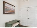 Welcoming entryway with a unique cabinet and double doors at 7036 E Sheena Dr, Scottsdale, AZ 85254