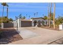 Wide driveway with a basketball hoop complements this attractive Southwestern style home at 7036 E Sheena Dr, Scottsdale, AZ 85254