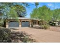 Charming home with a well-maintained front yard, featuring mature trees and a two-car garage at 7202 N 16Th Dr, Phoenix, AZ 85021