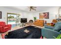 Cozy living room with a fireplace, tile floors, stylish decor, and sliding glass doors at 7318 S Mcallister Ave, Tempe, AZ 85283