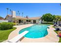 Beautiful backyard with a diving pool, well-kept lawn, mature trees, and an outdoor lounge area at 7318 S Mcallister Ave, Tempe, AZ 85283