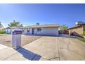 Well-kept home with concrete driveway and low-maintenance front yard, a modern and clean exterior at 7332 W Desert Cove Ave, Peoria, AZ 85345