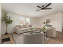 Cozy living room featuring neutral furniture, wood flooring, and soft, natural lighting at 9735 W Altadena Dr, Casa Grande, AZ 85194