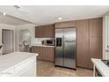 Kitchen featuring ample cabinet space, stainless steel appliances, white countertops, and tile flooring at 9825 N 44Th Ave, Glendale, AZ 85302