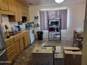 Traditional kitchen featuring wooden cabinets, white appliances, and tile floors at 1116 E Almeria Rd, Phoenix, AZ 85006