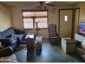 Vintage living room featuring green tile flooring, a ceiling fan, and a variety of seating options at 1116 E Almeria Rd, Phoenix, AZ 85006