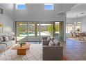 Bright living room with soaring ceilings, modern furnishings, and a view of the backyard pool at 11534 E Downing St, Mesa, AZ 85207