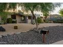 Charming home with xeriscape landscaping, featuring cacti and mature desert trees at 13034 N 8Th Ave, Phoenix, AZ 85029