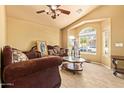 Cozy living room with a large window and vaulted ceiling, perfect for relaxing and entertaining at 1619 E Aspen Ave, Buckeye, AZ 85326