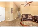 Inviting living area with neutral paint and tile flooring that seamlessly connects to other areas at 1619 E Aspen Ave, Buckeye, AZ 85326