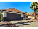 This inviting home features a well-manicured front yard and an attached two-car garage at 1736 E Bluefield Ave, Phoenix, AZ 85022