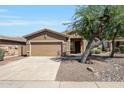 Inviting single-Gathering home featuring a neutral color palette, two-car garage, and low-maintenance landscaping at 18371 W Capistrano Ave, Goodyear, AZ 85338