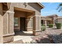 Charming front porch with decorative columns and detailed stucco, offering a welcoming entrance to the home at 18371 W Capistrano Ave, Goodyear, AZ 85338