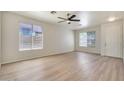 Bright and spacious living room with neutral walls, wood-look floors, and large windows for natural light at 18371 W Capistrano Ave, Goodyear, AZ 85338
