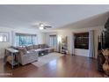 Spacious living room with hard surface floors, a ceiling fan, and multiple windows at 21061 N 33Rd Dr, Phoenix, AZ 85027